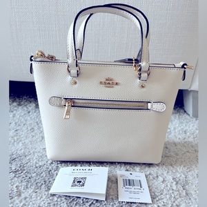 Coach mini top handle/crossbody bag. New with tag. Authentic & never been used.